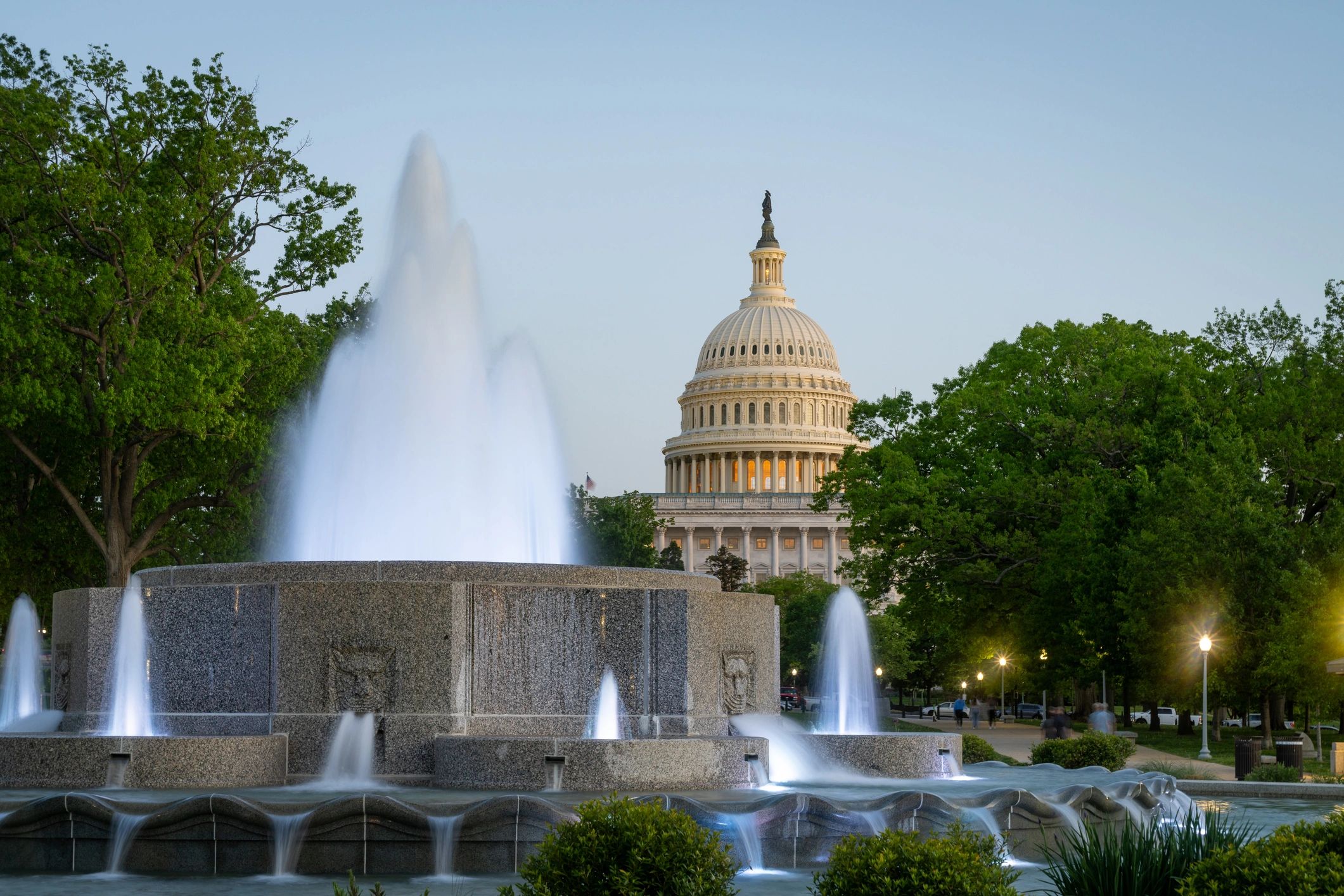 US Capitol dome and fountain at dusk in Washington, DC